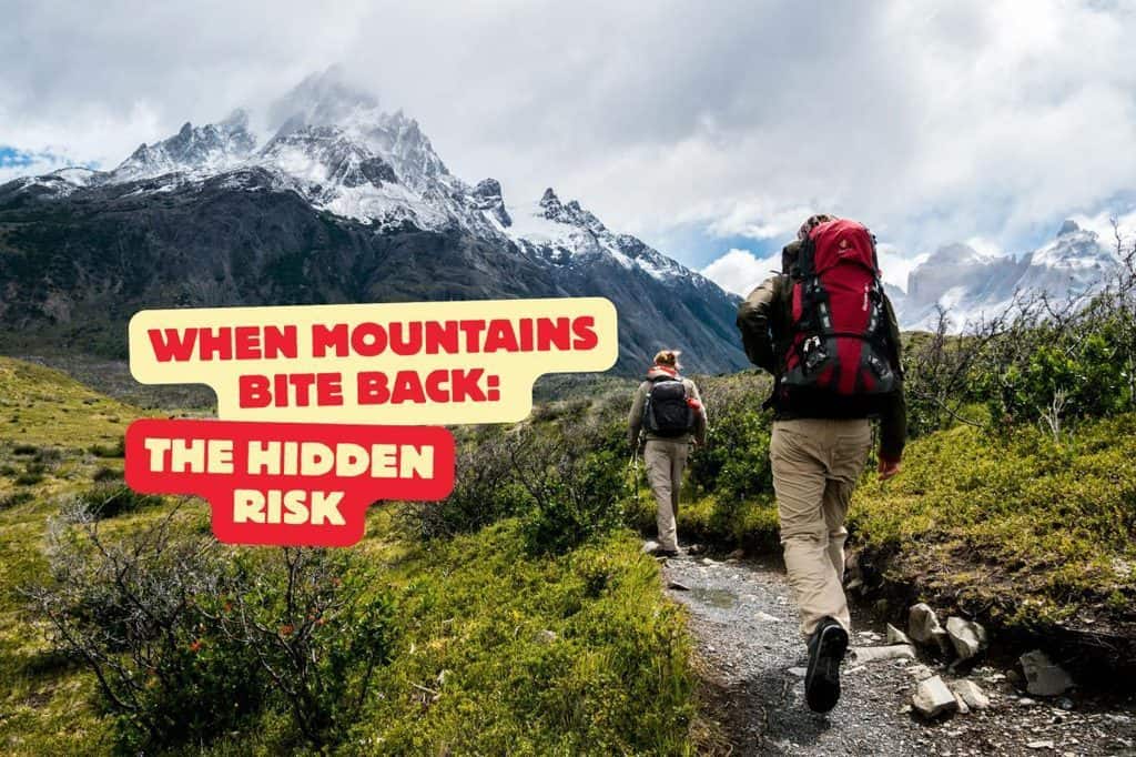 Hikers trekking through mountain landscape with snow-capped peaks.